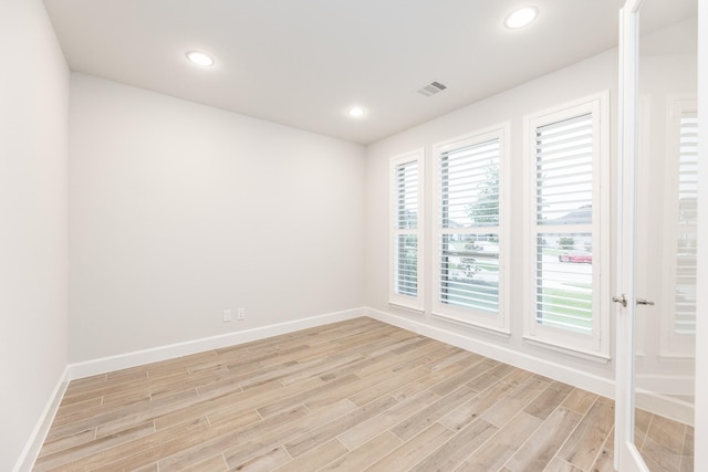 spare room with light hardwood / wood-style flooring