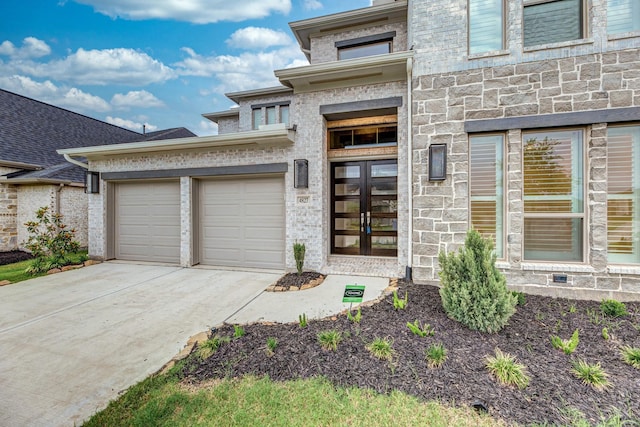 view of front facade with a garage and french doors