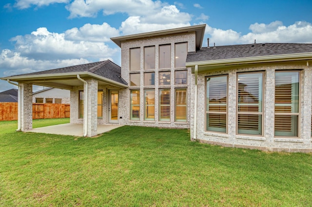 back of house featuring a yard and a patio area