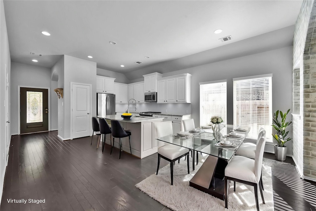 dining area featuring dark hardwood / wood-style flooring and sink