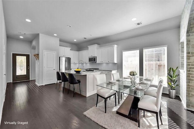 dining area featuring dark hardwood / wood-style flooring and sink