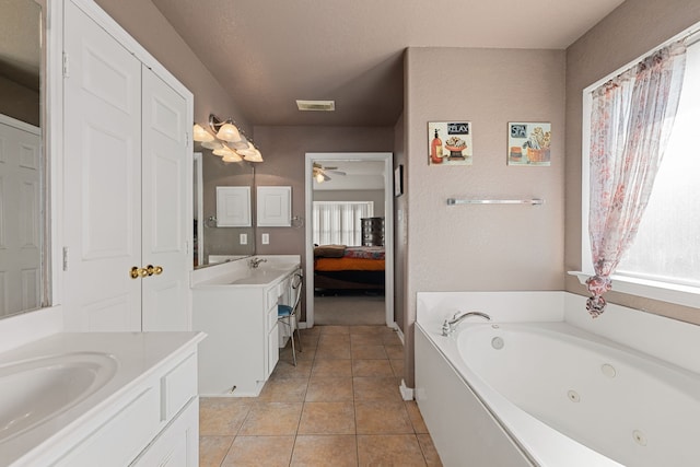 bathroom featuring tile patterned flooring, vanity, ceiling fan, and a tub to relax in