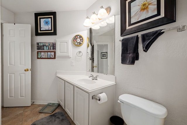 bathroom with tile patterned floors, vanity, and toilet