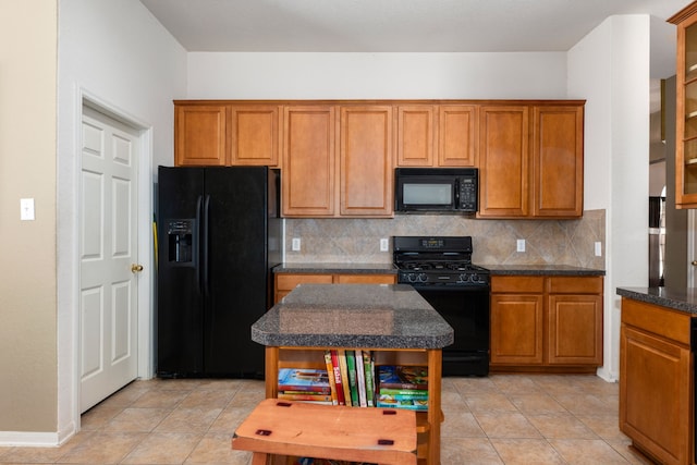 kitchen with black appliances, decorative backsplash, and light tile patterned floors