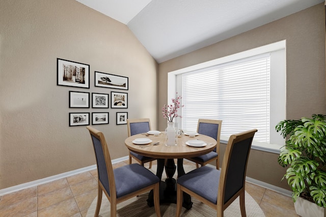 tiled dining space with vaulted ceiling