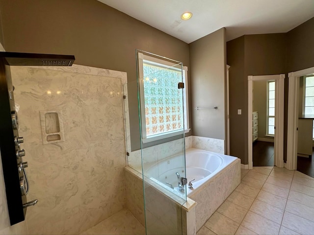 bathroom featuring tile patterned floors and separate shower and tub