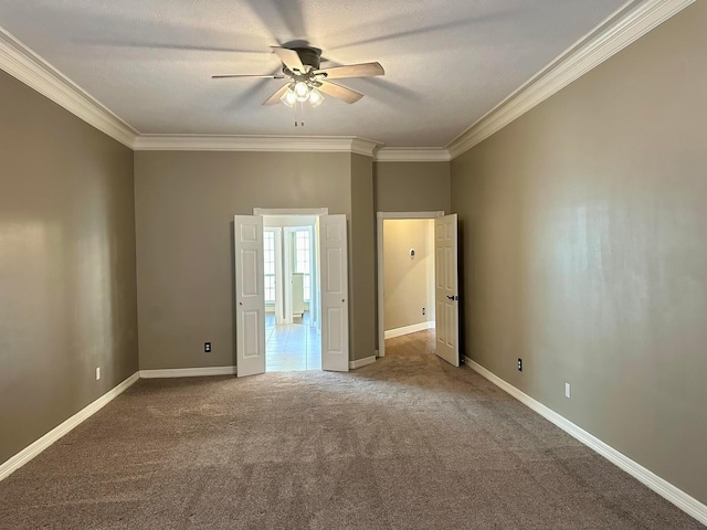 unfurnished bedroom with ceiling fan, crown molding, carpet, and a textured ceiling