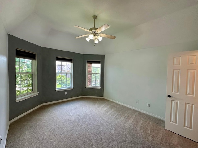 carpeted empty room with ceiling fan and lofted ceiling