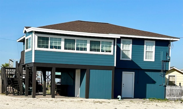 rear view of property featuring a carport