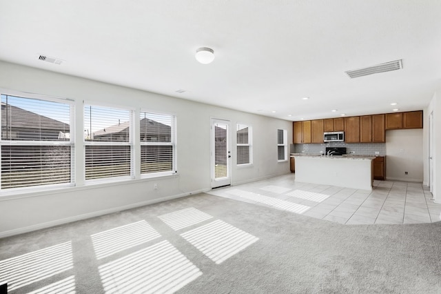 unfurnished living room with light colored carpet