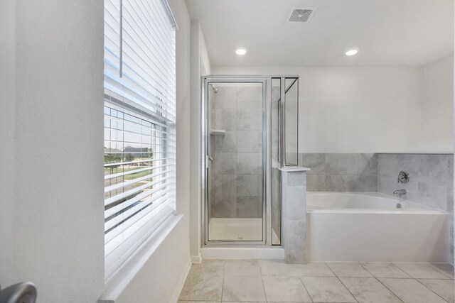 bathroom with tile patterned flooring and independent shower and bath