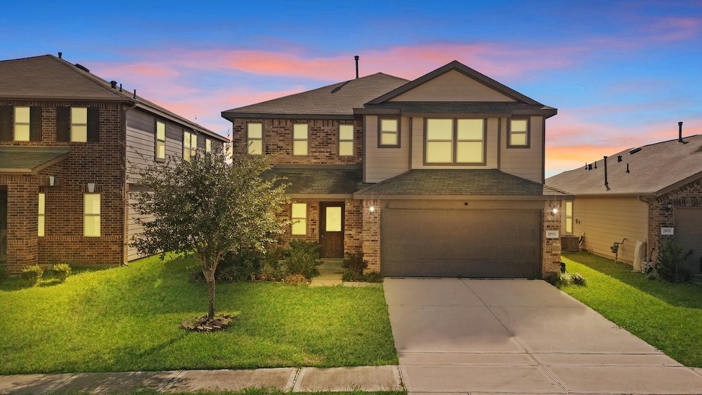 view of front of house with a yard and a garage