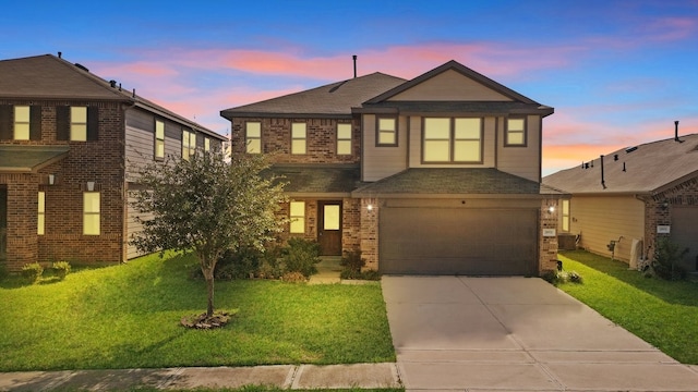 view of front of house with a yard and a garage