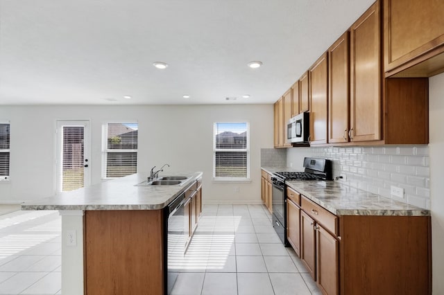 kitchen with a kitchen island with sink, plenty of natural light, black appliances, and sink