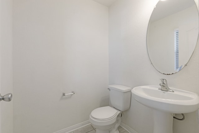 bathroom featuring tile patterned flooring and toilet