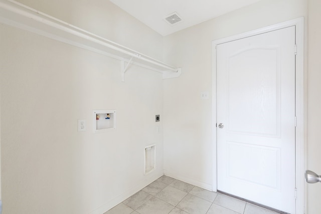 laundry room with hookup for a washing machine, light tile patterned floors, and electric dryer hookup