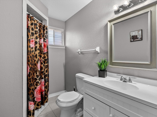 bathroom featuring tile patterned floors, walk in shower, vanity, and toilet