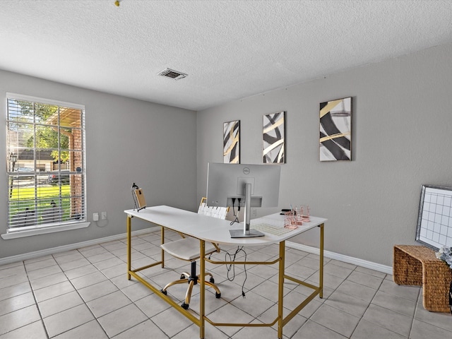 tiled office featuring a textured ceiling