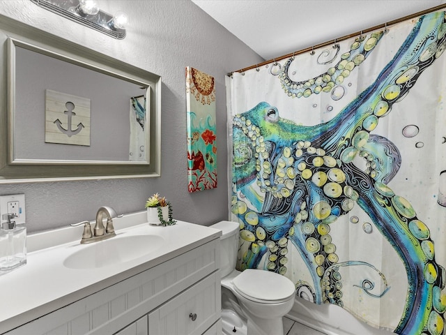 bathroom featuring a textured ceiling, vanity, and toilet