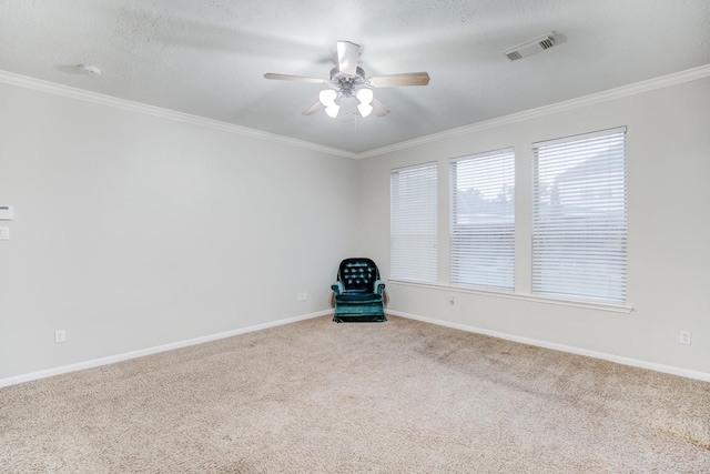 unfurnished room with a textured ceiling, ceiling fan, carpet floors, and ornamental molding