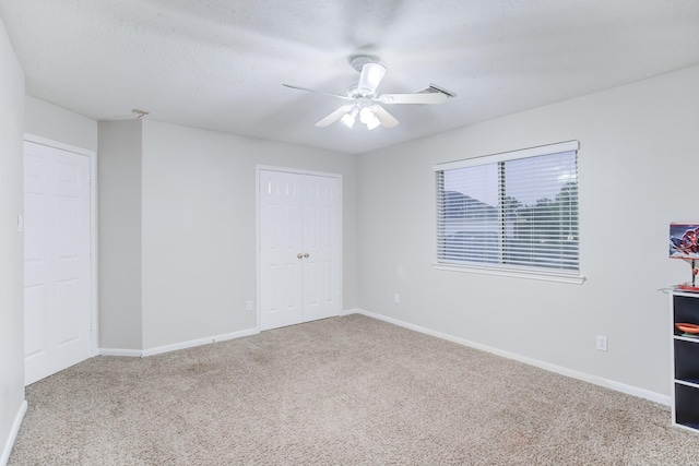 unfurnished room with carpet flooring and ceiling fan