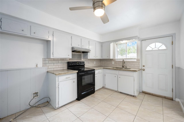 kitchen featuring tasteful backsplash, ceiling fan, sink, electric range, and white cabinetry