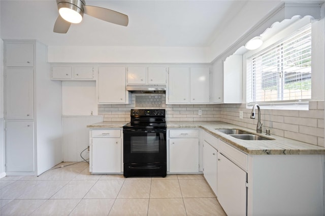 kitchen with white cabinetry, sink, light tile patterned floors, and black electric range