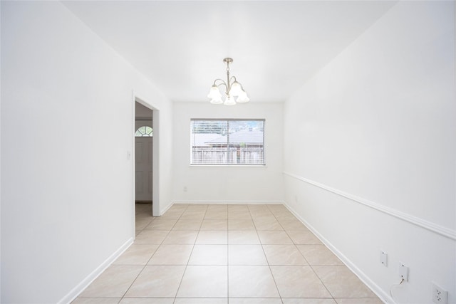 unfurnished dining area featuring light tile patterned flooring and a chandelier