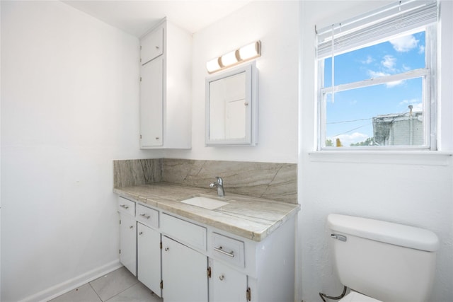 bathroom with tile patterned floors, vanity, and toilet