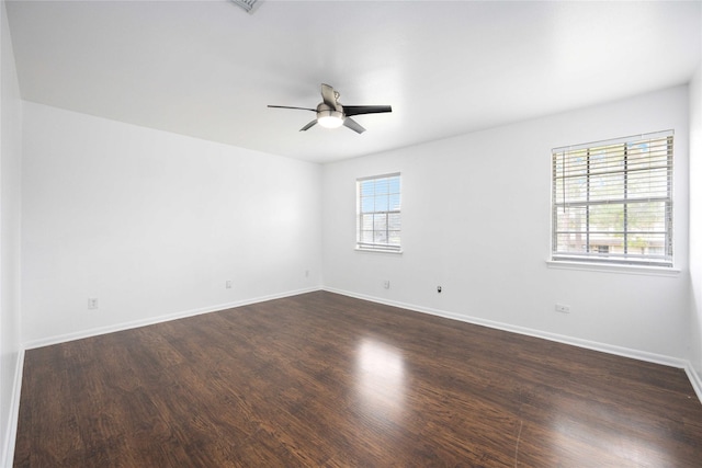 empty room featuring ceiling fan and dark wood-type flooring