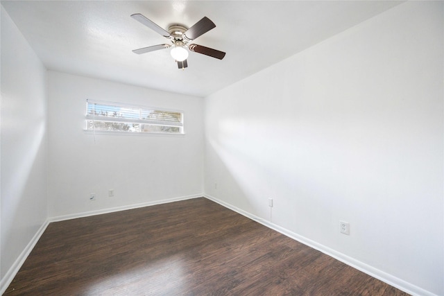 empty room with dark hardwood / wood-style floors and ceiling fan