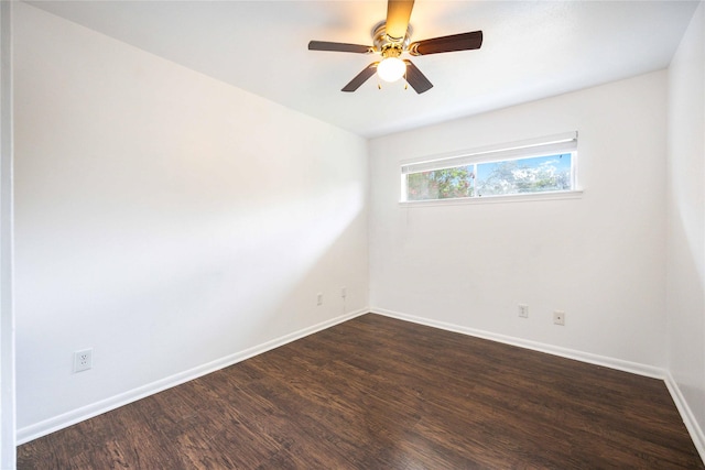 empty room with ceiling fan and dark wood-type flooring