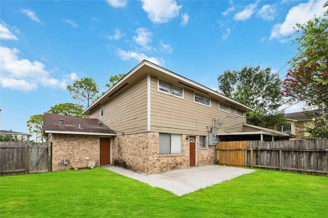 rear view of house featuring a patio and a lawn