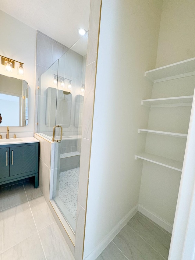 bathroom with vanity and a shower with shower door