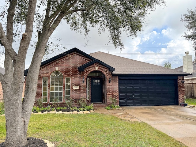 ranch-style house featuring a garage and a front yard