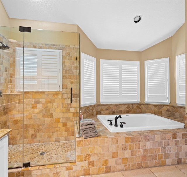 bathroom featuring tile patterned floors, a healthy amount of sunlight, lofted ceiling, and shower with separate bathtub