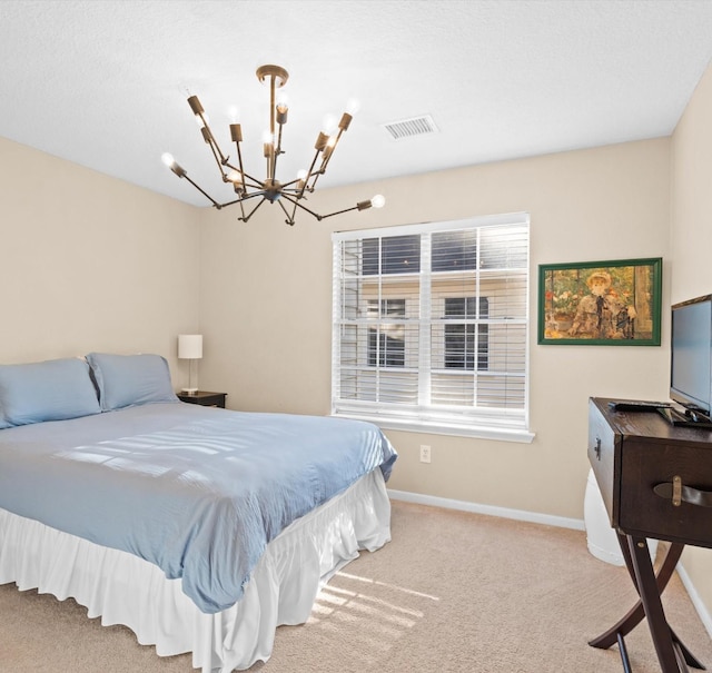 carpeted bedroom with a notable chandelier