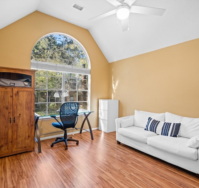 office area with ceiling fan, wood-type flooring, and vaulted ceiling