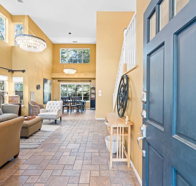 foyer with a high ceiling and an inviting chandelier