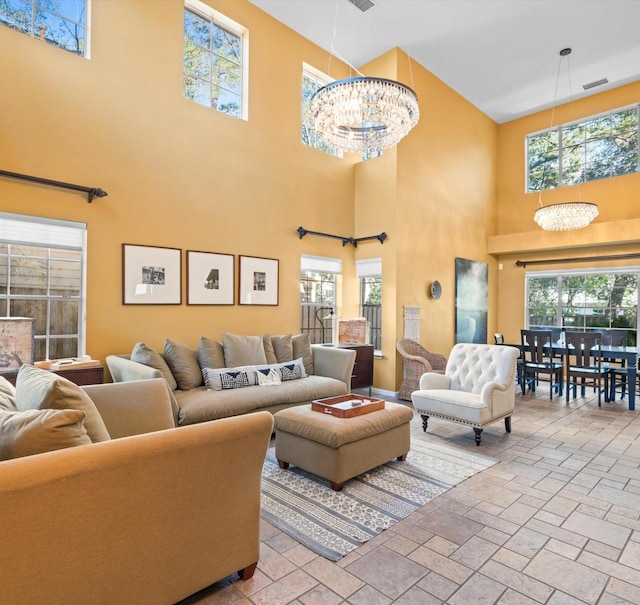 living room featuring a towering ceiling and an inviting chandelier