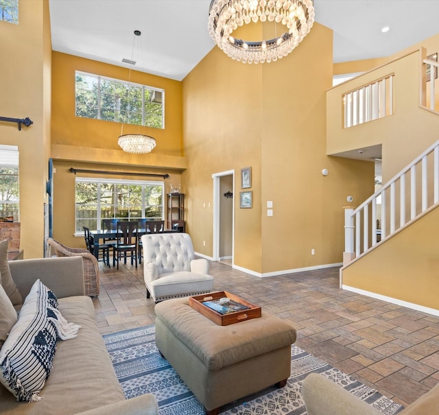 living room with a high ceiling and an inviting chandelier