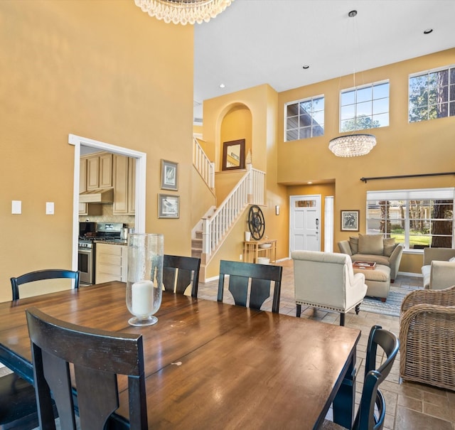 dining room with a high ceiling and an inviting chandelier