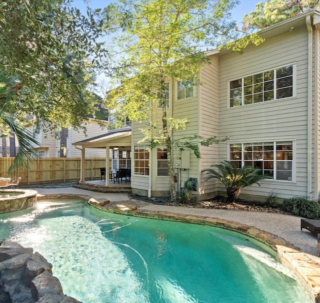 view of pool featuring a jacuzzi and a patio