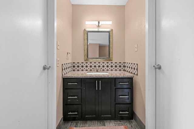 bathroom with vanity and wood-type flooring