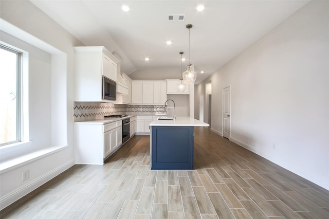 4030 Colony Ln, Missouri City, TX 77459 - kitchen featuring built in microwave, decorative backsplash, light countertops, white cabinets, and a sink