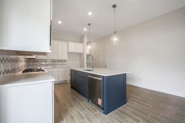 4030 Colony Ln, Missouri City, TX 77459 - kitchen with stainless steel appliances, a sink, light wood-type flooring, white cabinets, and tasteful backsplash