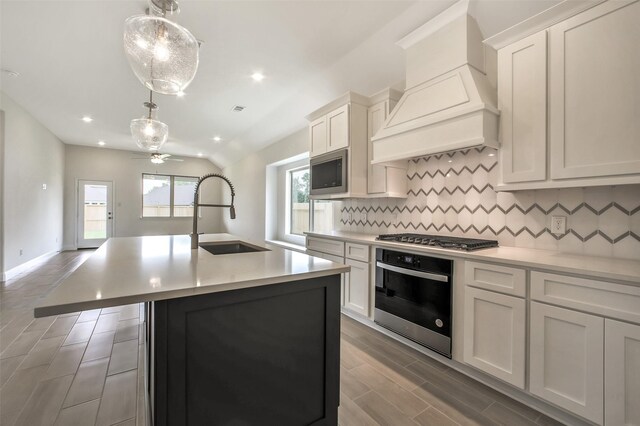 4030 Colony Ln, Missouri City, TX 77459 - kitchen with appliances with stainless steel finishes, a sink, custom range hood, backsplash, and a ceiling fan