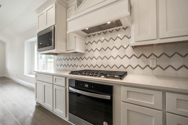 4030 Colony Ln, Missouri City, TX 77459 - kitchen with appliances with stainless steel finishes, premium range hood, light countertops, and decorative backsplash