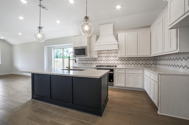 4030 Colony Ln, Missouri City, TX 77459 - kitchen featuring a sink, custom range hood, stainless steel microwave, decorative backsplash, and light countertops