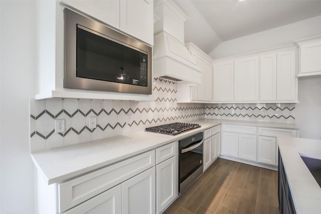 4030 Colony Ln, Missouri City, TX 77459 - kitchen featuring stainless steel appliances, white cabinets, light countertops, tasteful backsplash, and dark wood-type flooring